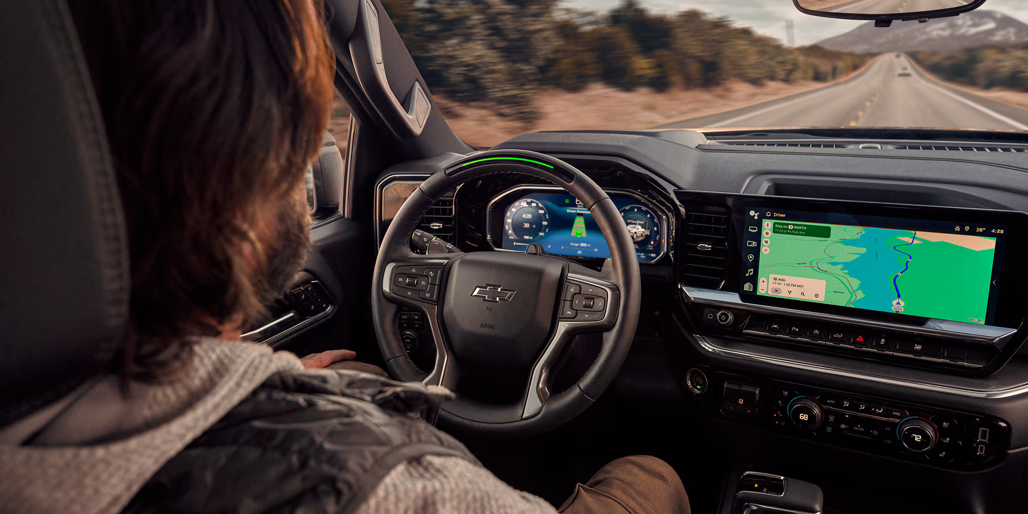 Interior of the 2026 Chevy Silverado 1500 with a driver using Driver Assistance technology.