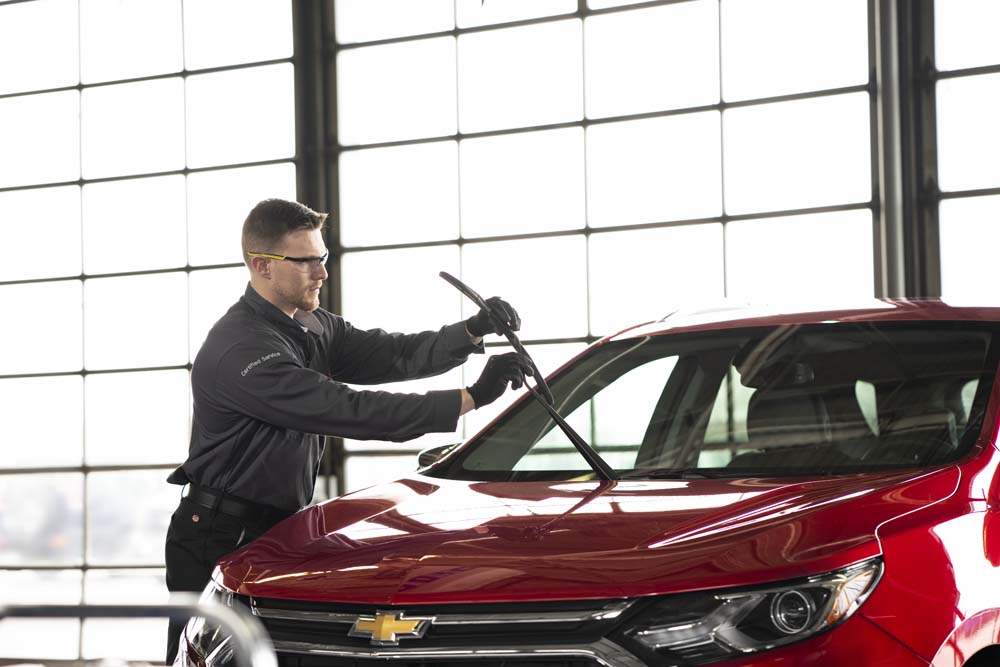 Chevy service tech inspecting wipers.