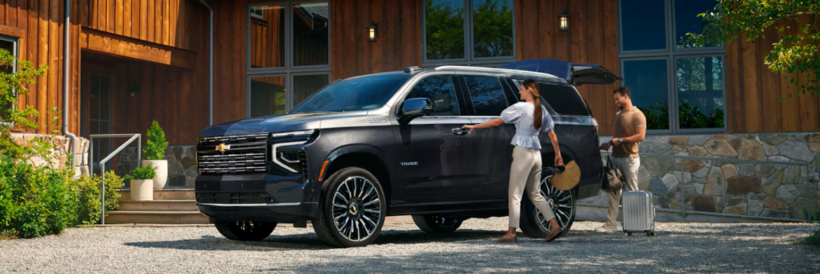 The 2026 Chevrolet Tahoe parked in front of family house with members opening suv doors