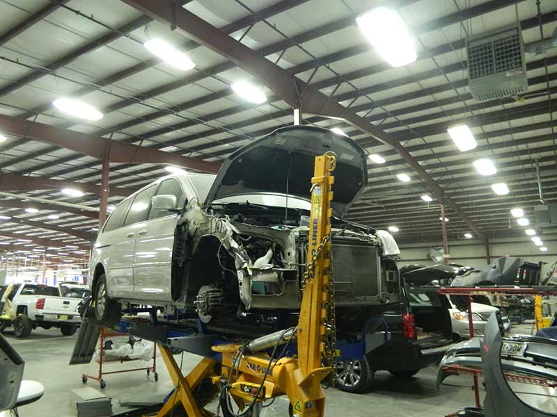 A van getting serviced on a lift