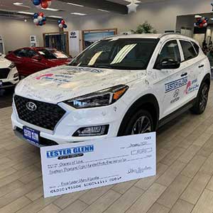 Lester Glenn donating money to a charity