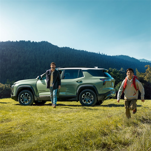 family on grass near 2026 Chevrolet Equinox ACTIV trim